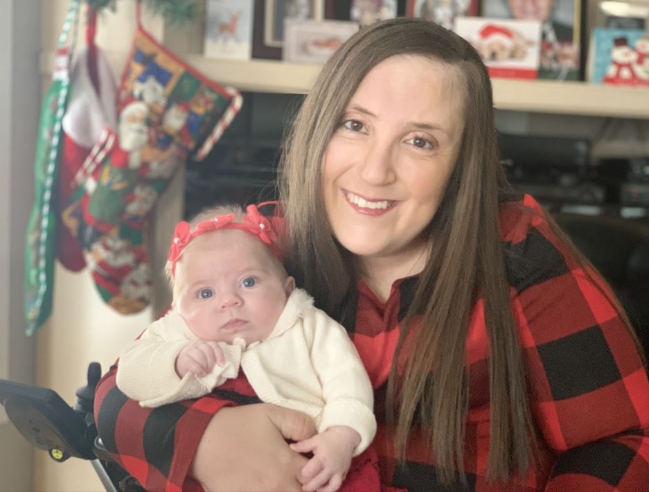 Gabriella, a self manager on the Direct Funding program, is pictured with her baby.