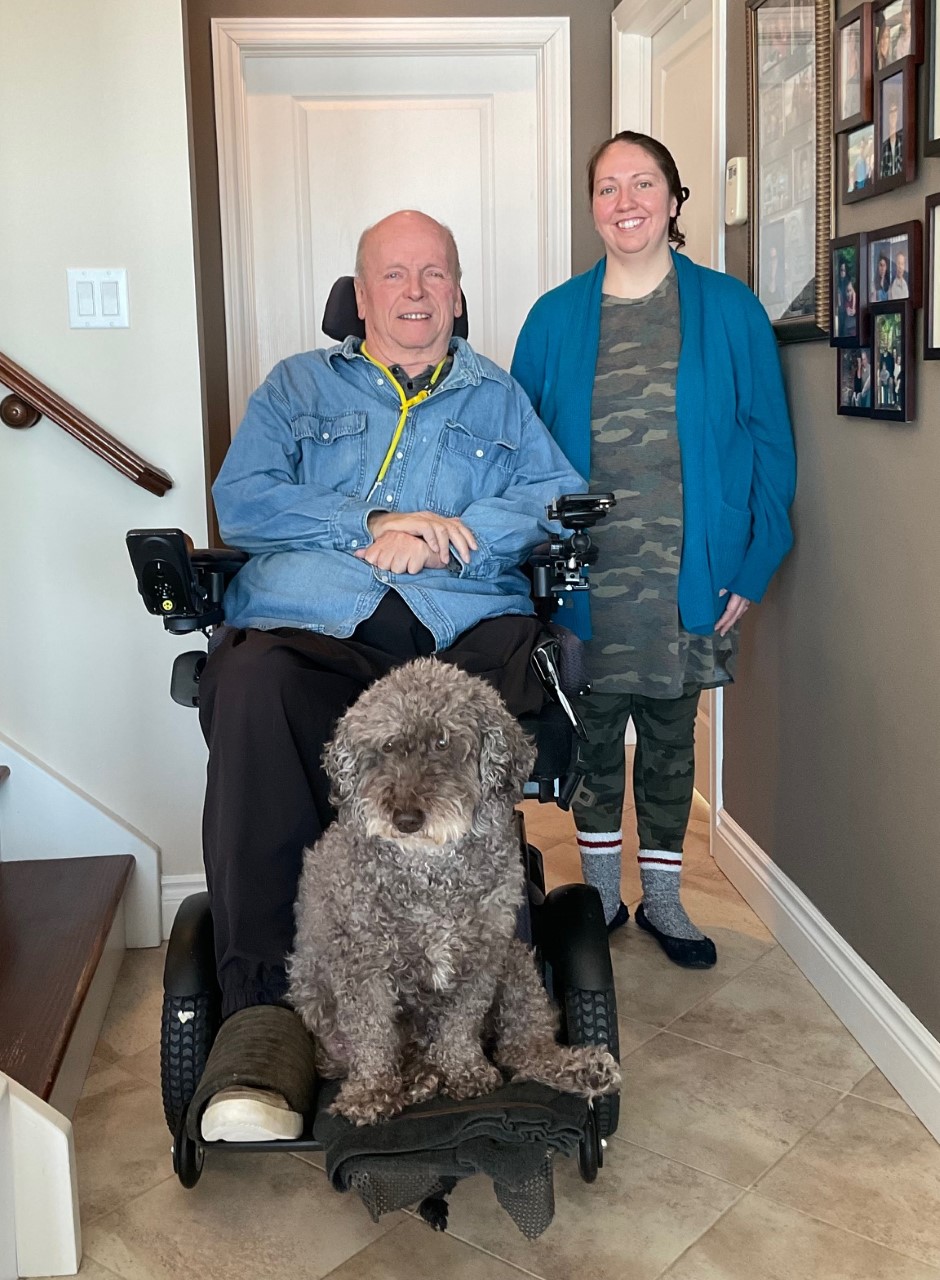 Stuart posing with his attendant and dog.